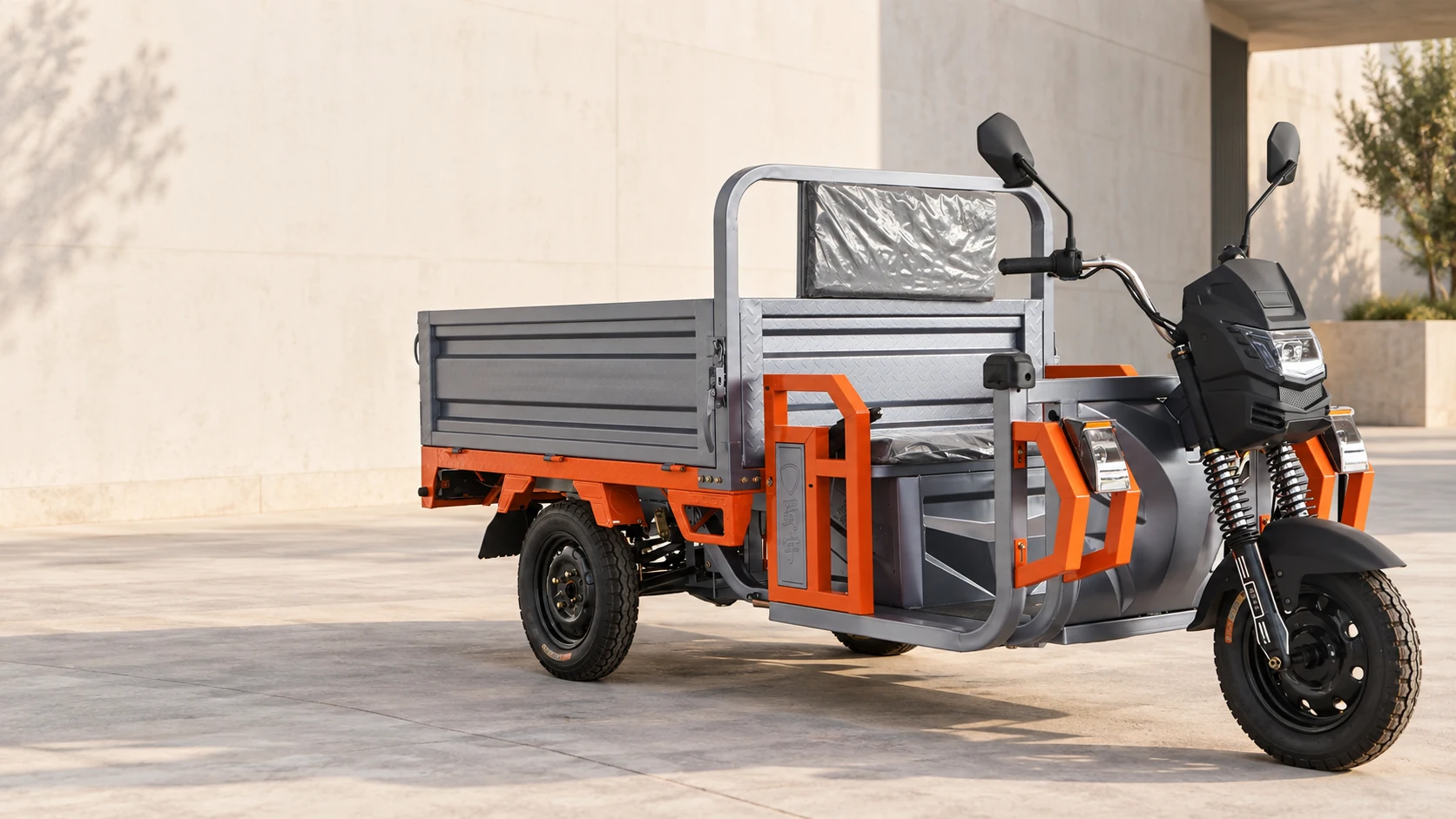 Gray and orange SCHI 160L cargo tricycle in an architectural courtyard